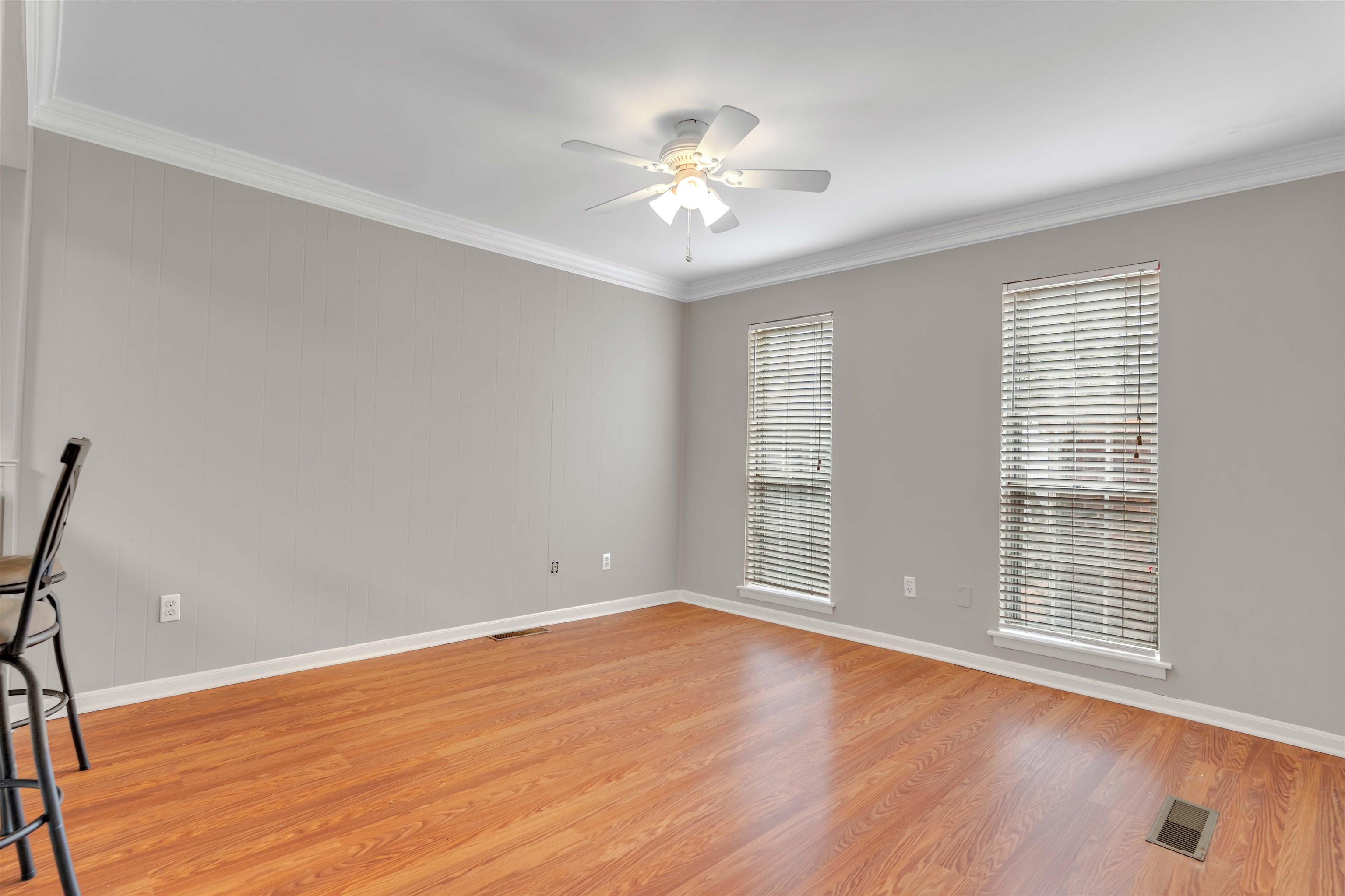 6942 Amberly Road, Unit 6942 Memphis, TN 38119 - Photo 7 of 32 a view of an empty room with wooden floor and a window
