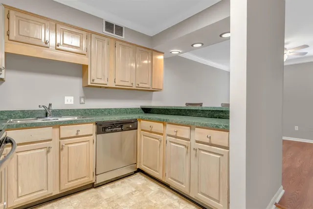 a kitchen with granite countertop white cabinets and white appliances
