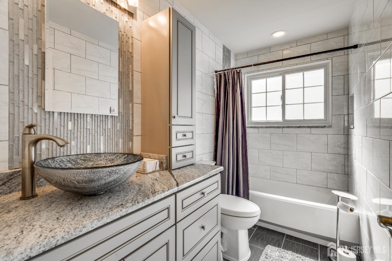 845 B Taylor Road Monroe Township, NJ 08831 - Photo 13 of 15 a bathroom with a granite countertop toilet a sink and a bathtub