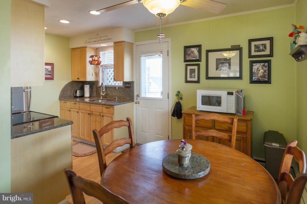940 Olmstead Road Baltimore, MD 21208 - Photo 7 of 30 Breakfast room opens to kitchen w/door to deck
