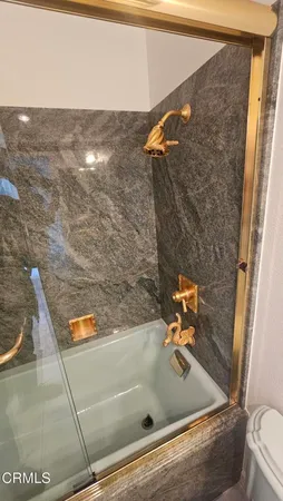 a bathroom with a toilet mirror and vanity