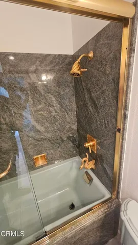 a bathroom with a toilet mirror and vanity