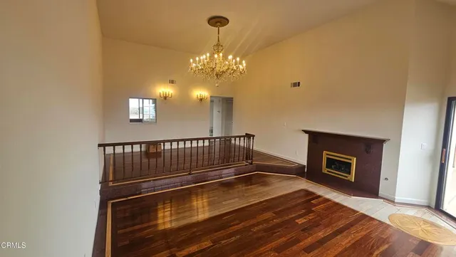 a view of livingroom with fireplace and chandelier