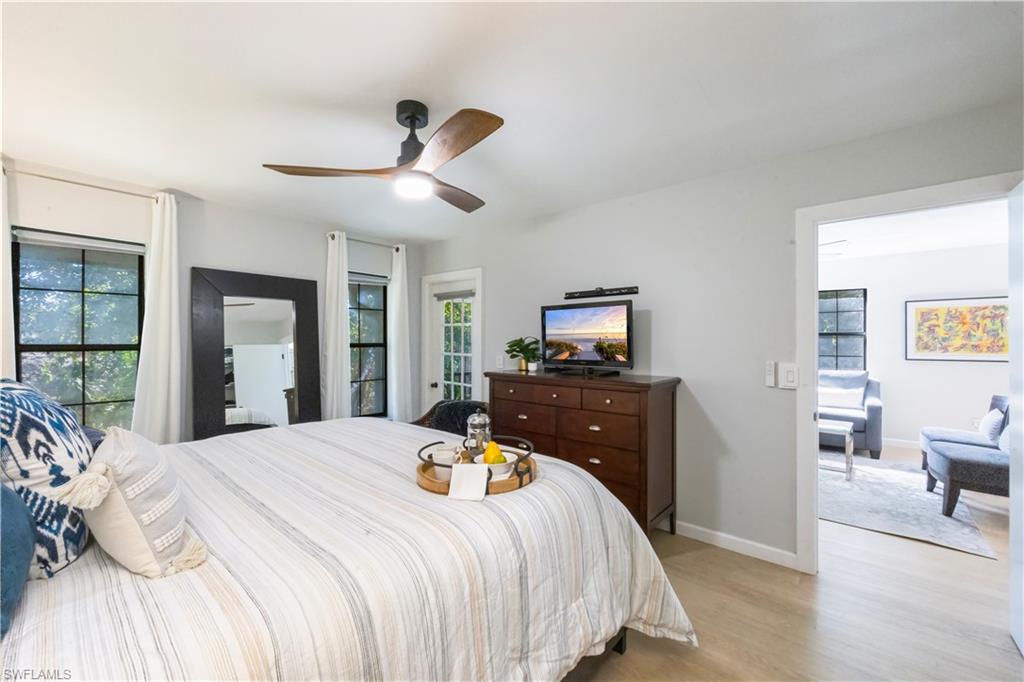 5238 Treetops Drive, Unit L201 Naples, FL 34113 - Photo 18 of 33 a bedroom with a bed and wooden floor