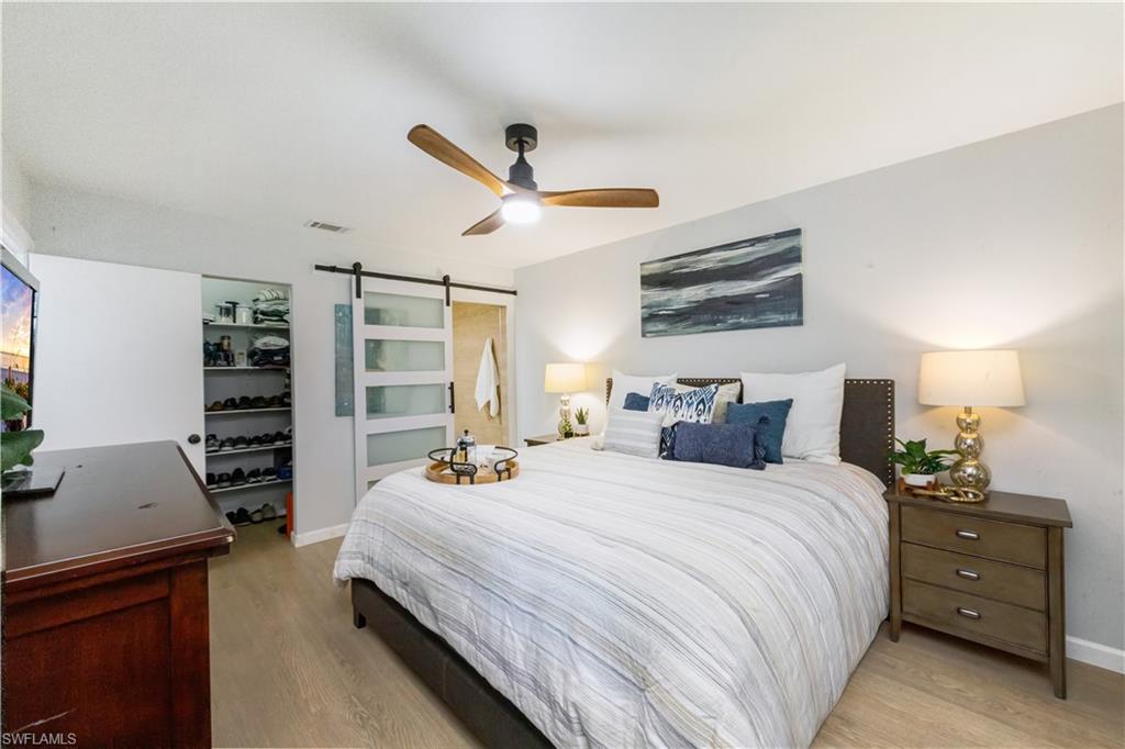 5238 Treetops Drive, Unit L201 Naples, FL 34113 - Photo 18 of 34 a bedroom with bed and a large window