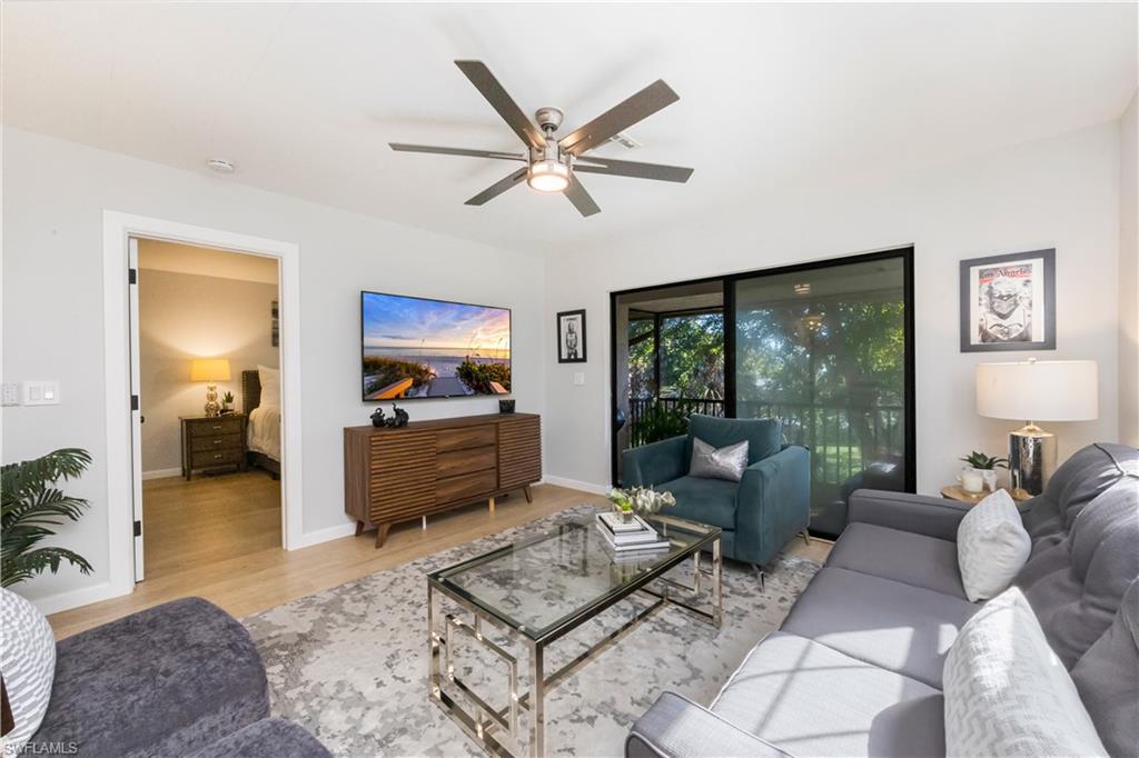 5238 Treetops Drive, Unit L201 Naples, FL 34113 - Photo 2 of 34 a living room with furniture and a large window