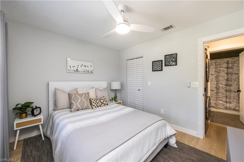 5238 Treetops Drive, Unit L201 Naples, FL 34113 - Photo 21 of 33 a bedroom with a bed and a potted plant