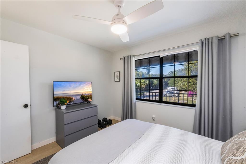 5238 Treetops Drive, Unit L201 Naples, FL 34113 - Photo 22 of 33 a bedroom with furniture and a window