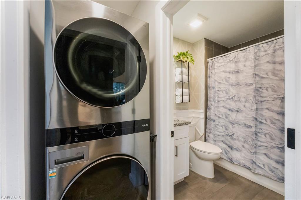 5238 Treetops Drive, Unit L201 Naples, FL 34113 - Photo 25 of 33 a bathroom with a toilet and a sink