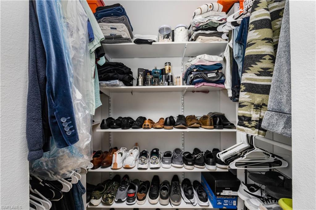5238 Treetops Drive, Unit L201 Naples, FL 34113 - Photo 25 of 34 a kitchen with lots of different colored cloths