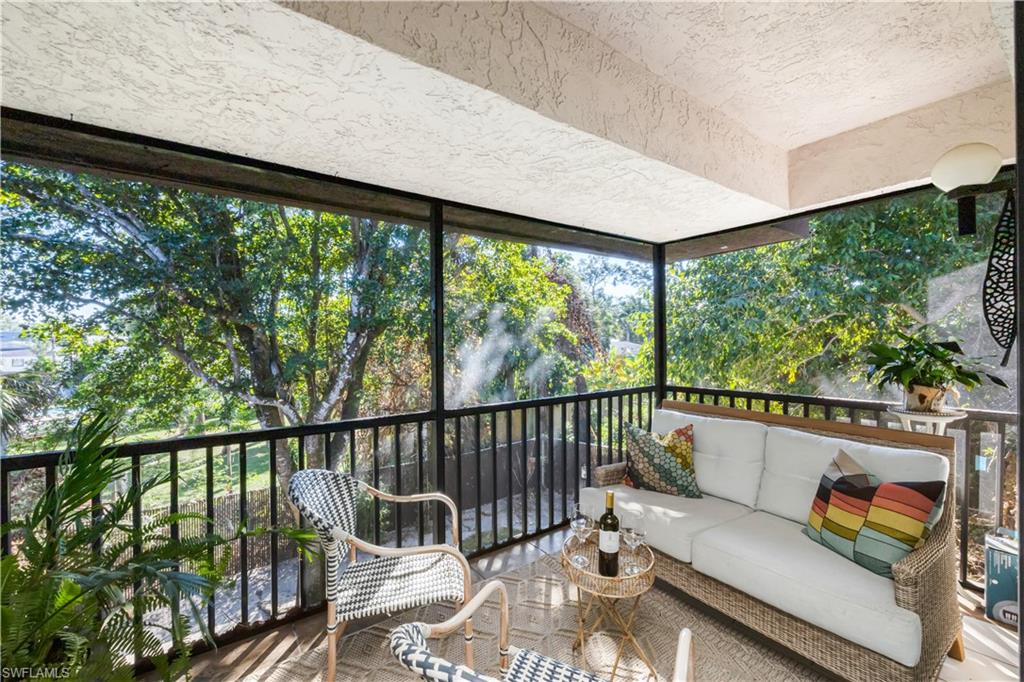 5238 Treetops Drive, Unit L201 Naples, FL 34113 - Photo 27 of 33 a view of a two chairs in the roof deck