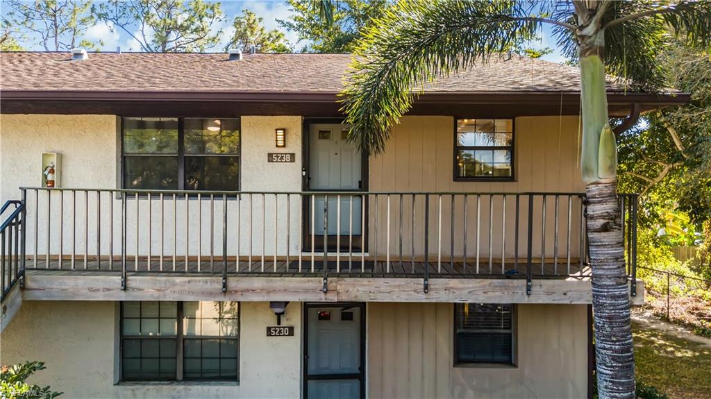 5238 Treetops Drive, Unit L201 Naples, FL 34113 - Photo 30 of 34 a view of a house with a wooden fence