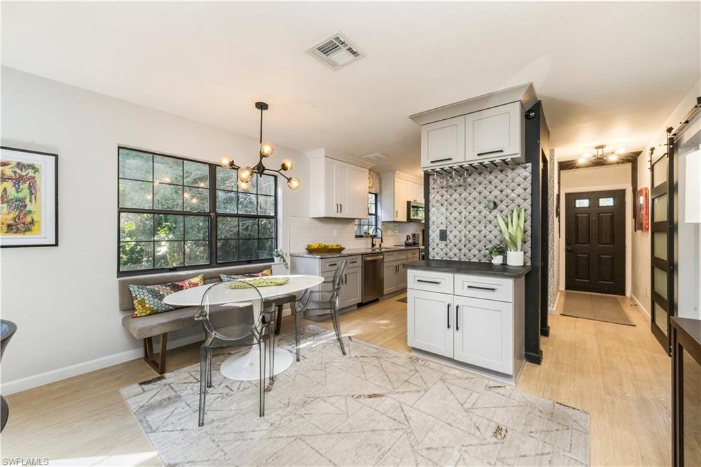 5238 Treetops Drive, Unit L201 Naples, FL 34113 - Photo 3 of 34 a open kitchen with granite countertop a stove a sink and a refrigerator