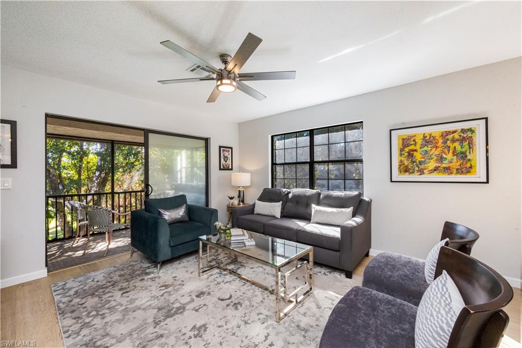 5238 Treetops Drive, Unit L201 Naples, FL 34113 - Photo 4 of 34 a living room with furniture ceiling fan and a window