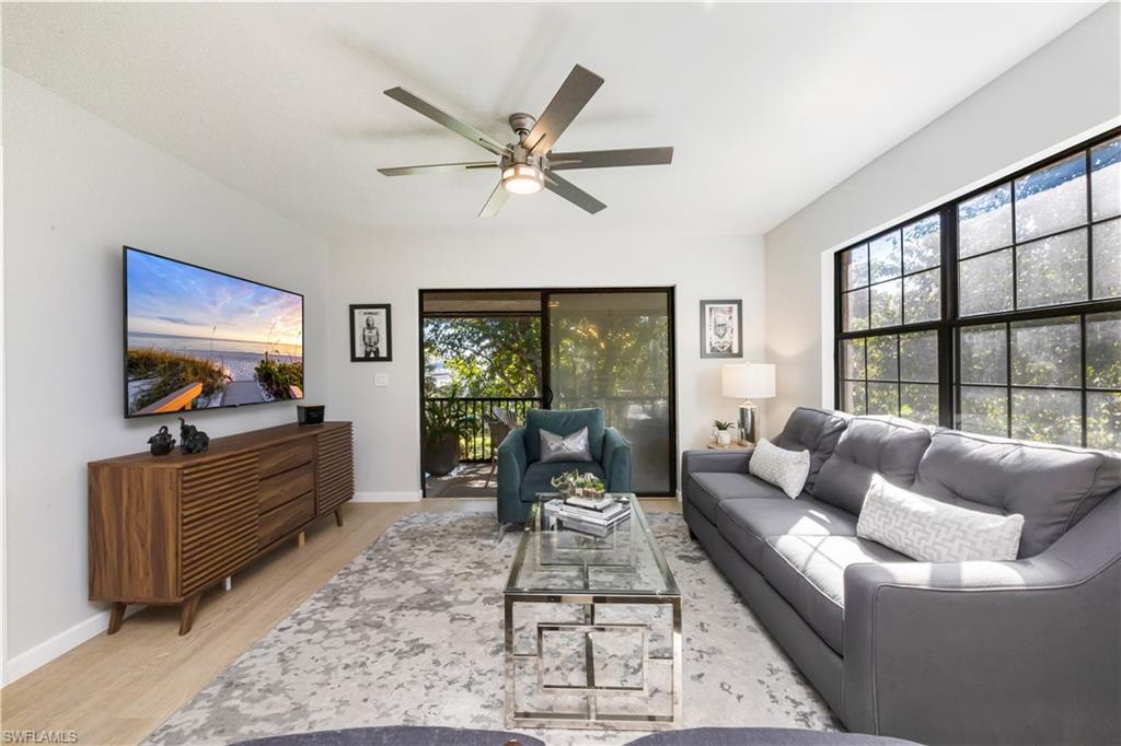 5238 Treetops Drive, Unit L201 Naples, FL 34113 - Photo 5 of 34 a living room with furniture and a flat screen tv