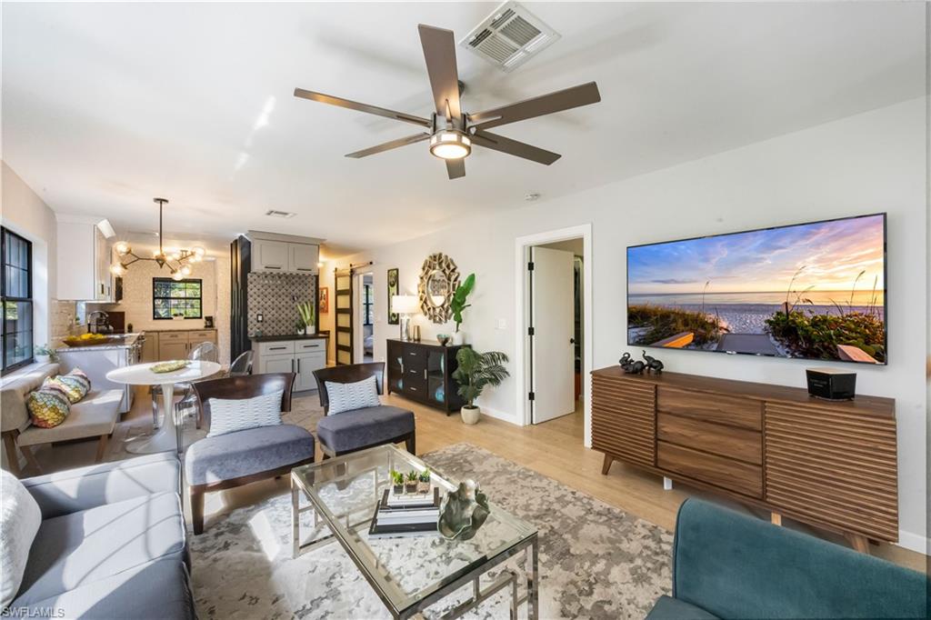 5238 Treetops Drive, Unit L201 Naples, FL 34113 - Photo 7 of 34 a living room with furniture and a flat screen tv