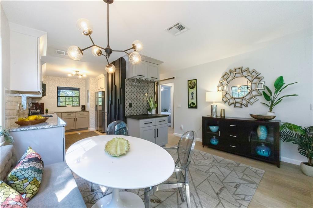 5238 Treetops Drive, Unit L201 Naples, FL 34113 - Photo 9 of 34 a living room with furniture a chandelier a rug and a chandelier