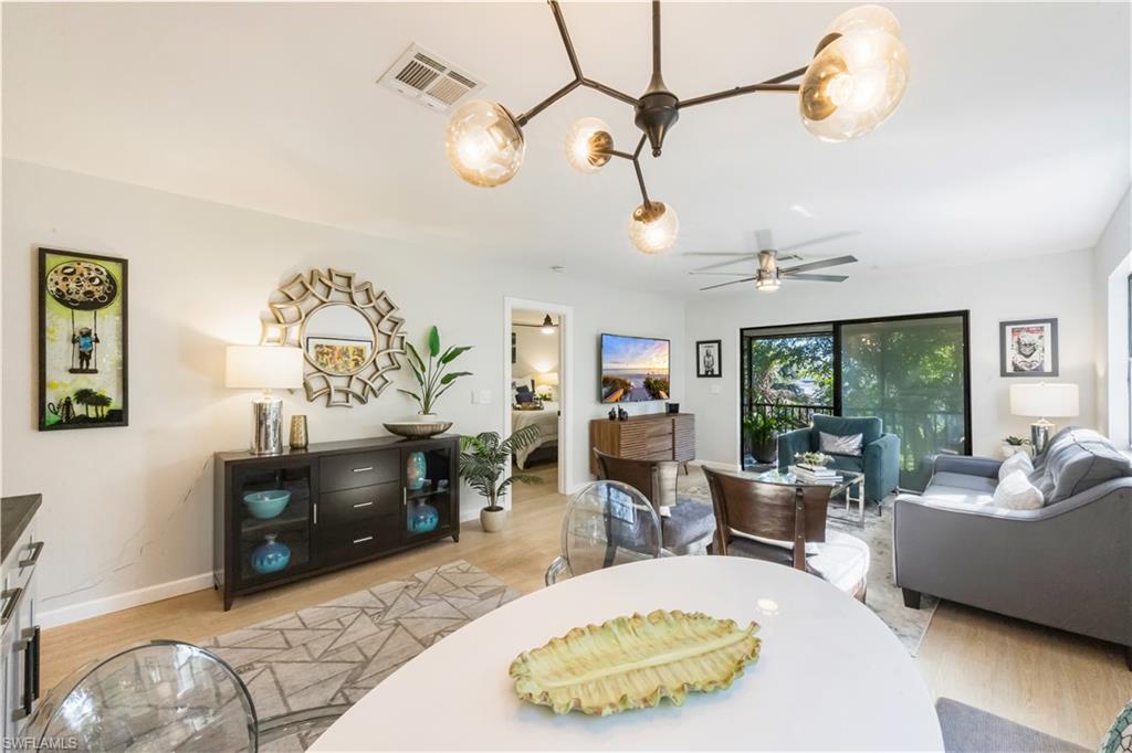 5238 Treetops Drive, Unit L201 Naples, FL 34113 - Photo 10 of 34 a living room with furniture and a flat screen tv