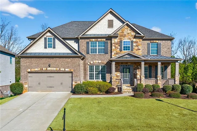 a view of staircase with railing and white walls
