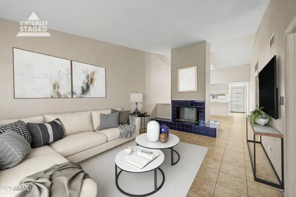 a living room with furniture a fireplace and a flat screen tv