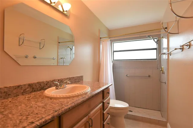 a bathroom with a sink toilet and shower