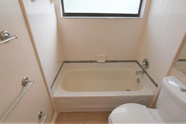 a bathroom with a bathtub and toilet