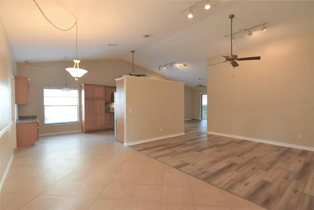 a view of a room with windows and ceiling fan