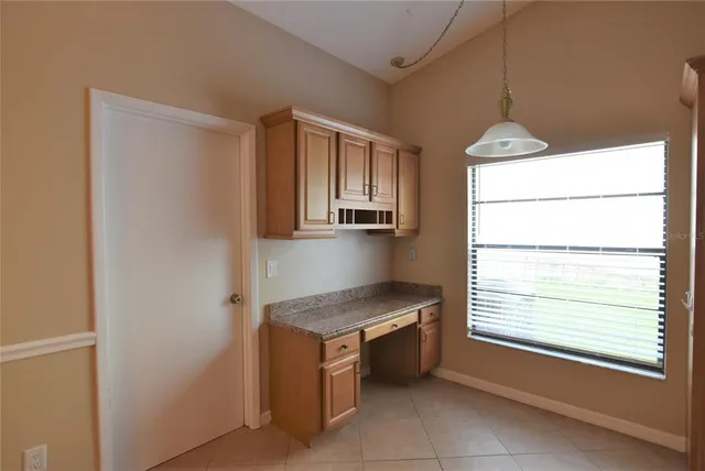 a kitchen with kitchen island a counter top space appliances and a window