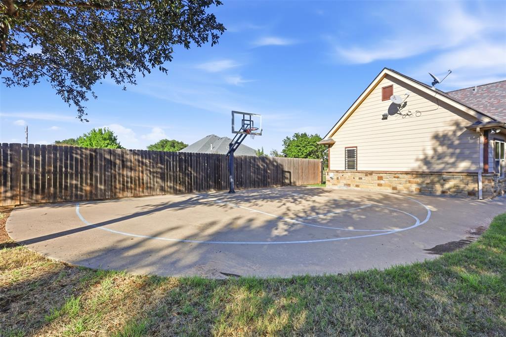 207 Dennis Road Lipan, TX 76462 - Photo 38 of 40 Concrete sport court with painted markings and an adjustable basketball hoop