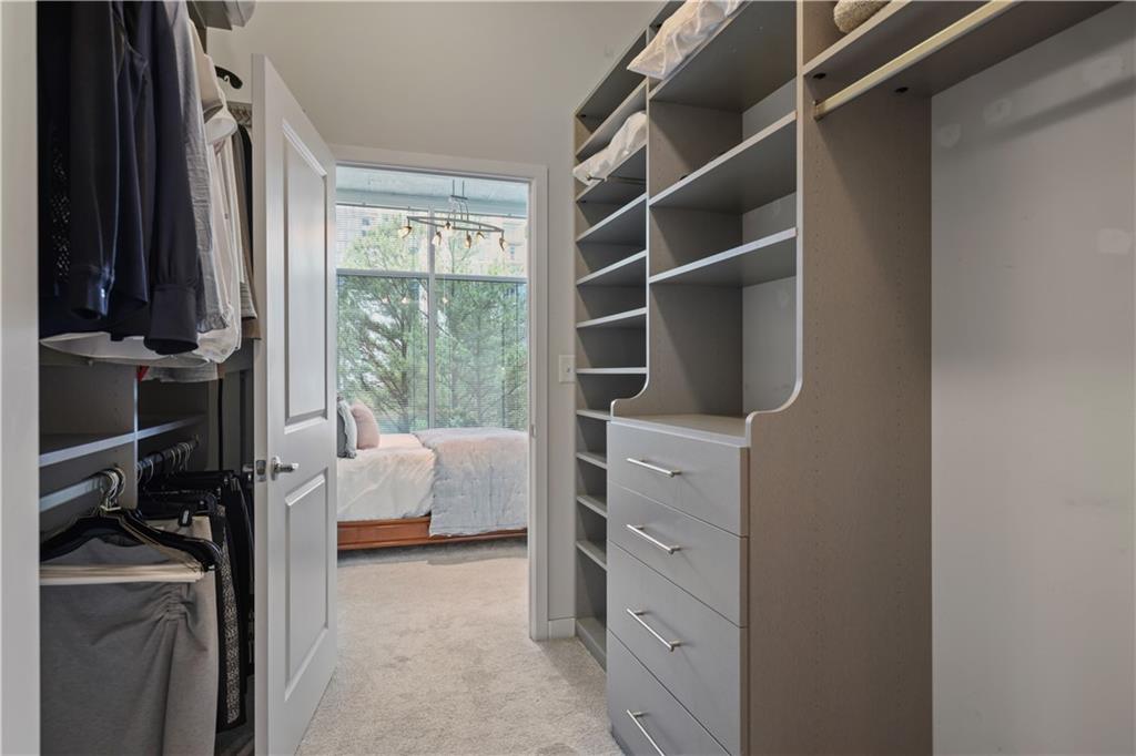 250 Pharr Road Northeast, Unit 606 Atlanta, GA 30305 - Photo 15 of 31 a bedroom with a bed and a window