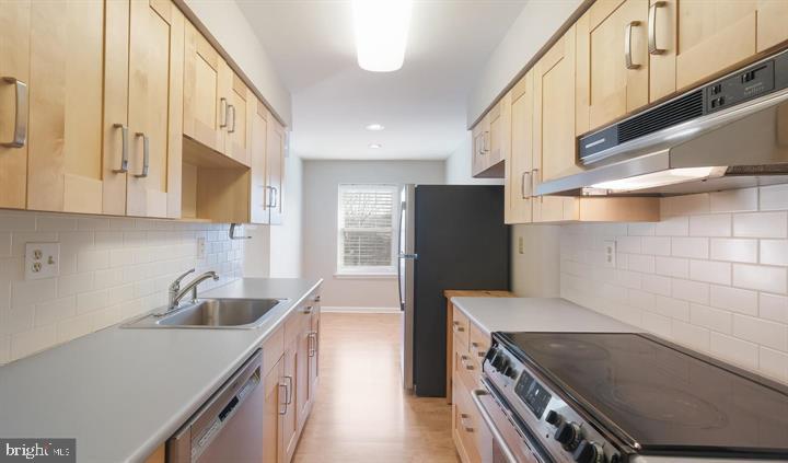 1430 Washington Place Chesterbrook, PA 19087 - Photo 14 of 44 a kitchen with stainless steel appliances a sink a stove and a refrigerator