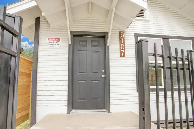 a front view of a house with a white door and wooden door