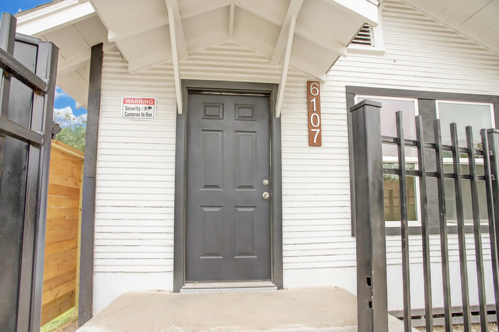 6107 North Main Street Houston, TX 77008 - Photo 2 of 14 a front view of a house with a white door and wooden door