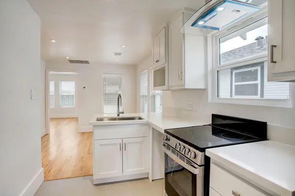 a kitchen that has a sink and a stove in it