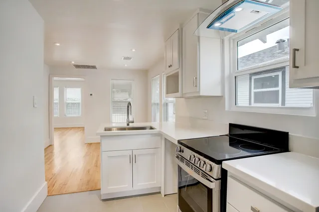 a kitchen that has a sink and a stove in it