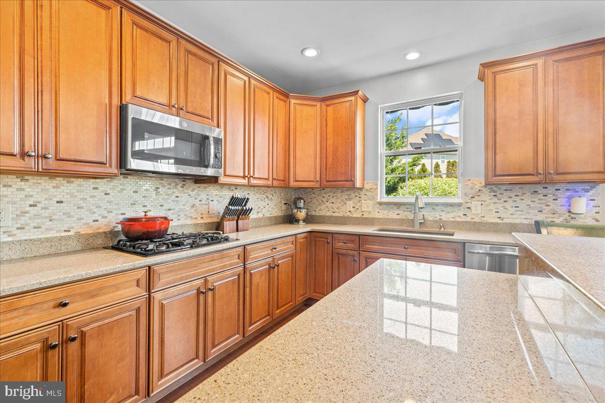 2650 Valhalla Road Vineland, NJ 08361 - Photo 12 of 49 a kitchen with stainless steel appliances granite countertop a sink a stove a microwave cabinets and a window