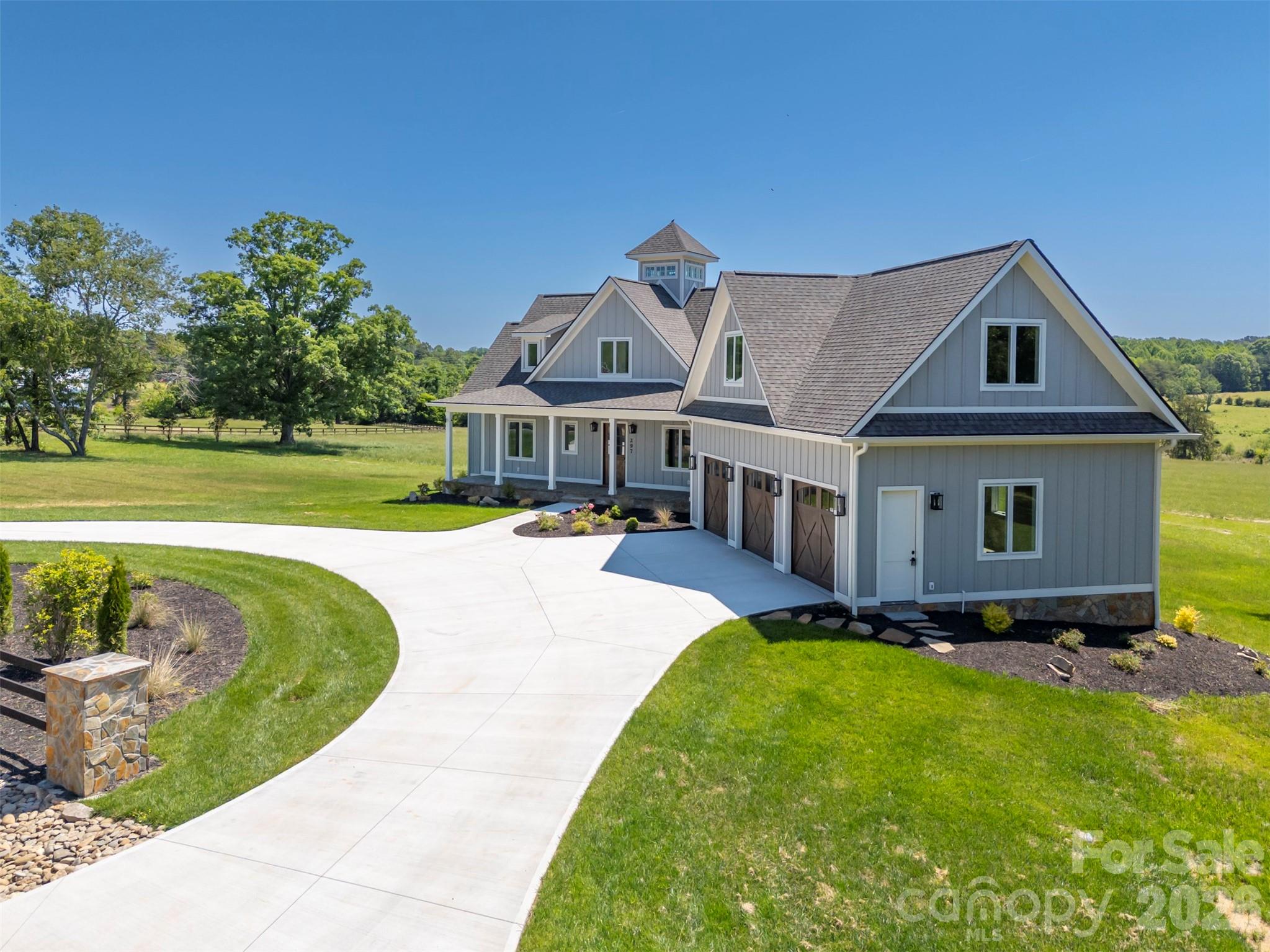 297 Mountain Meadows Lane, Unit 7 Tryon, NC 28782 - Photo 42 of 47 a front view of a house with a yard table and chairs
