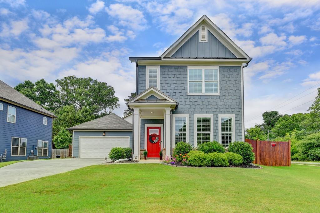 a front view of a house with a yard and garage
