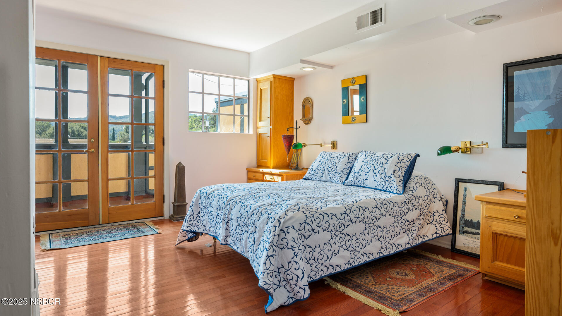 437 2nd Street Solvang, CA 93463 - Photo 13 of 39 a bedroom with a bed and wooden floor