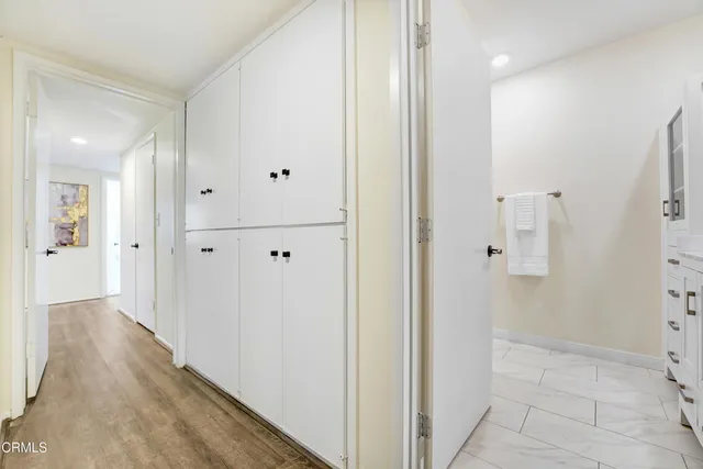 a view of a hallway with wooden floor