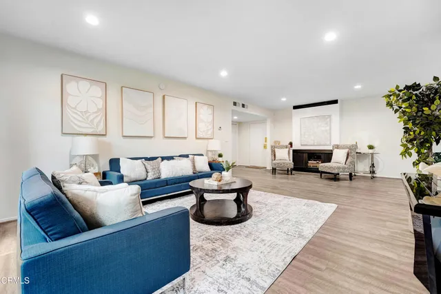 a living room with furniture and flowers