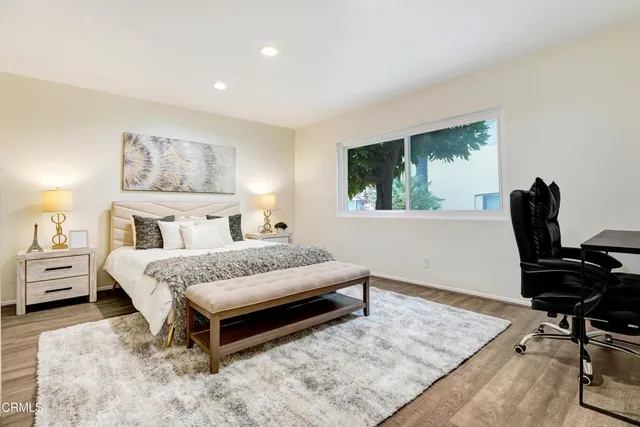 a bedroom with a bed and a desk