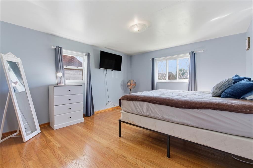 2354 Ritchie Street Aliquippa, PA 15001 - Photo 17 of 43 a bedroom with a bed and a flat tv screen on dresser