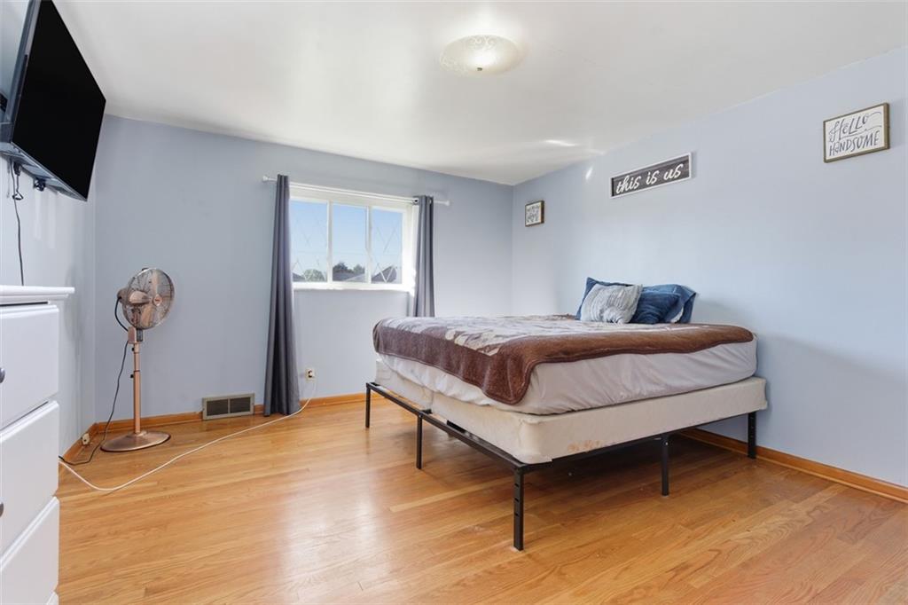 2354 Ritchie Street Aliquippa, PA 15001 - Photo 18 of 43 a bedroom with a bed and a flat screen tv