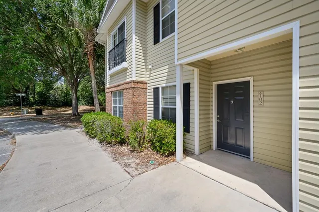a kitchen with a refrigerator and white cabinets
