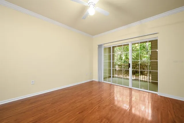a view of a kitchen with wooden floor and a ceiling fan