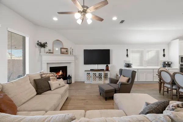 a living room with furniture fireplace and a flat screen tv