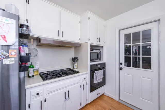 a kitchen with stainless steel appliances granite countertop a stove and a refrigerator