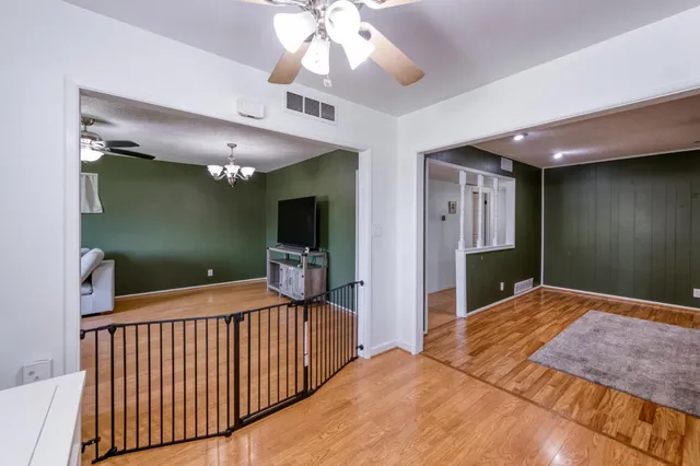 a bedroom with a bed and a flat tv screen on dresser