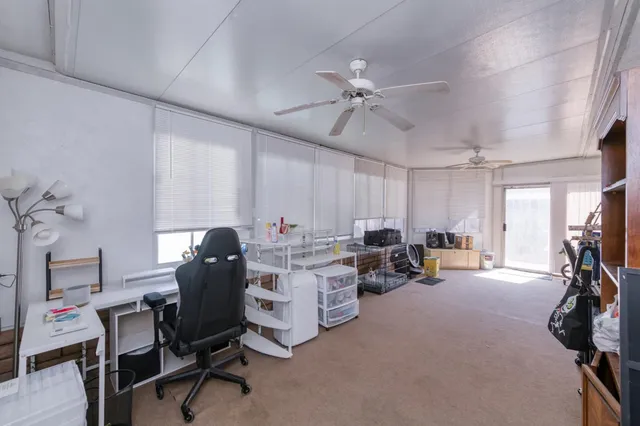 a view of a workspace with furniture and a window